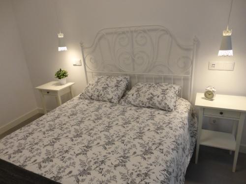 a bedroom with a bed and two night stands at Casa Aveiro Canal da Ria in Aveiro