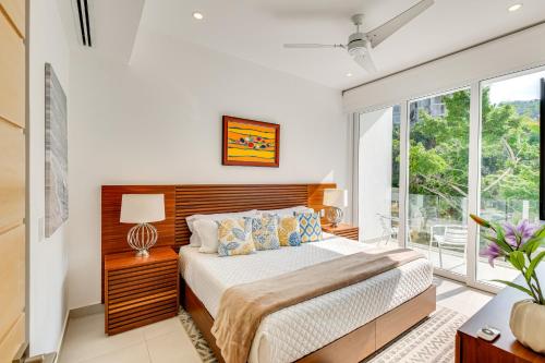 a bedroom with a bed and a large window at Puerto Vallarta Resort Condo, On-Site Beach Access in Puerto Vallarta
