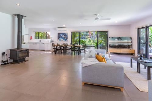 a living room with a couch and a stove at Bali by the Bay - Tarbuck Bay in Smiths Lake