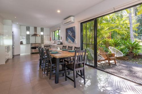 a kitchen and dining room with a table and chairs at Bali by the Bay - Tarbuck Bay in Smiths Lake