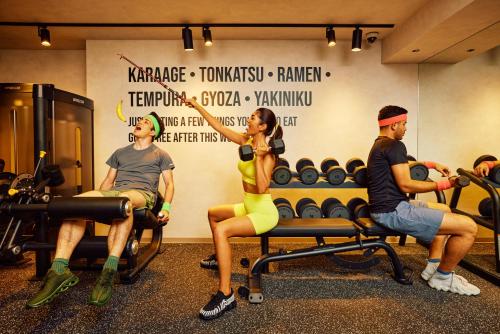 a group of people sitting in a gym at Section L Shimbashi West in Tokyo