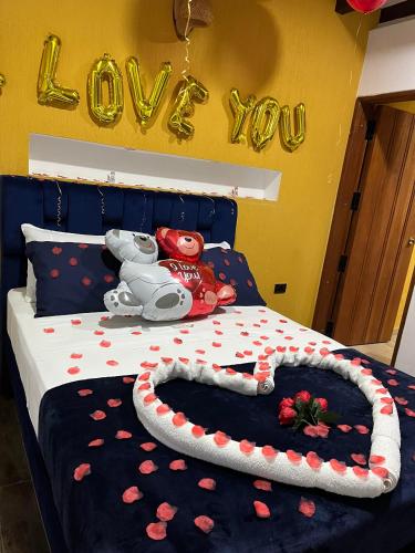 a bedroom with a bed with a sign that says love at Casa Iris Hotel Boutique in Barichara