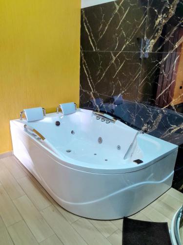 a white bath tub sitting in a bathroom at Casa Iris Hotel Boutique in Barichara