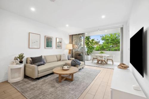 a living room with a couch and a table at Unit 307 'Drift' in Coolum Beach