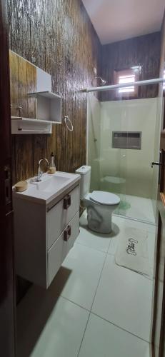 a bathroom with a sink and a toilet in it at Lazer Paracuru in Paracuru