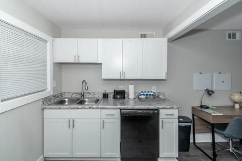 a kitchen with white cabinets and a sink at Buckhead 2BR Free Parking & Wi-Fi in Atlanta