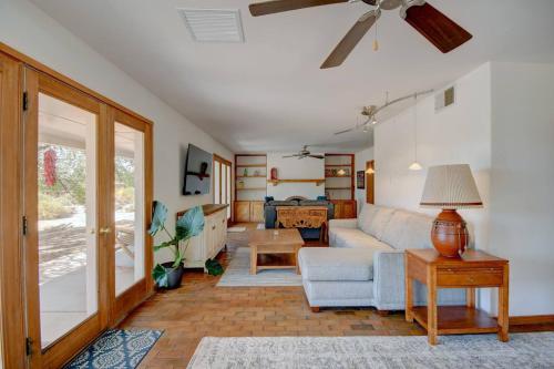 a living room with a couch and a ceiling fan at El Ranchito Alegre Taos-Style 3BR in Corrales in Corrales