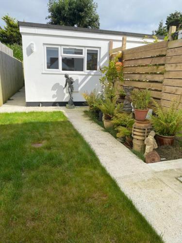 a tiny house in a backyard with plants at Seashells in Padstow