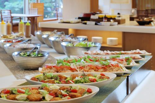 a buffet with many plates of food on a table at Zao Kokusai Hotel in Zao Onsen