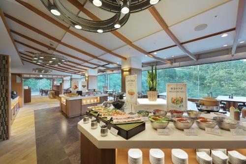 a kitchen with a buffet of food on a table at Zao Kokusai Hotel in Zao Onsen
