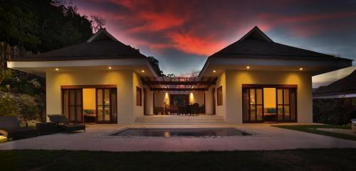 a house with a pool in front of it at Bluewater Sumilon Island Resort in Sumilon Island