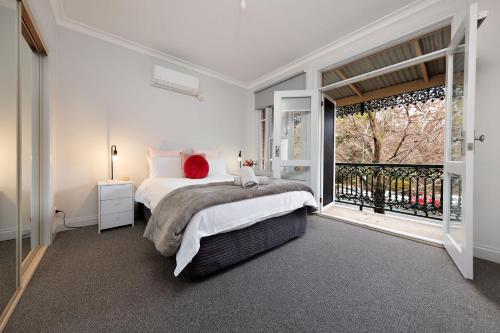 a bedroom with a bed and a large window at Central Style at the Gardens in Albury