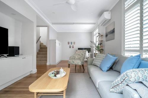 a living room with a couch and a table at The Newtowner - In the Heart of Newtown! in Sydney