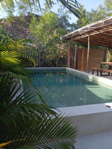 a swimming pool in a backyard with a pergola at Les Twins in Hinkong