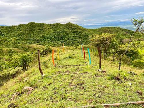 a group of colorful flags on a hill at Finca El Mirador - Agroturismo in Rivera
