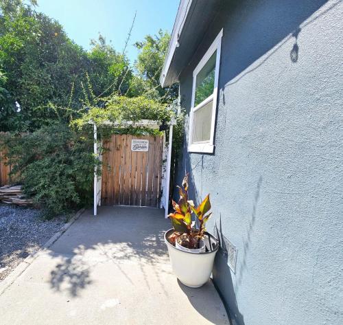 a door to a house with a potted plant next to it at Garden Clara in Yuba City