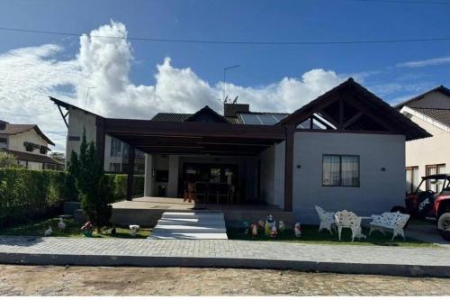 a house with some figurines in front of it at Chalé Exclusivo Condomínio Águas da Serra in Bananeiras
