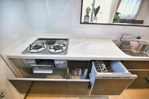 a kitchen with a stove and a sink at アキラ商事 in Tokyo