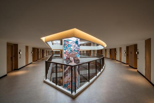 a hallway in a building with a mural on the wall at M Social Hotel Phuket in Patong Beach