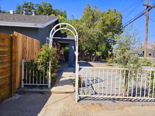 a white gate in front of a house at Garden Clara in Yuba City