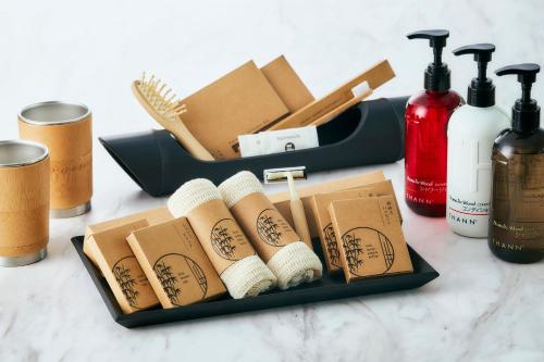 a black tray with toilet paper rolls and bottles of soap at Park Hotel Tokyo in Tokyo