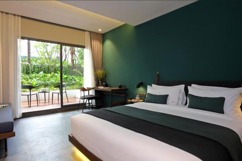Postel nebo postele na pokoji v ubytování Baitong Hotel & Resort Phnom Penh
