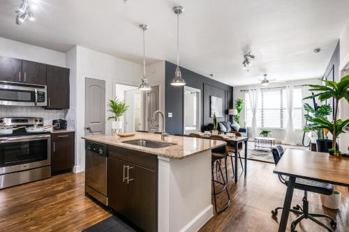 an open kitchen and living room with a dining table at Stylish 2B2B Near Toyota HQ The Star Legacy West 2359 in Frisco
