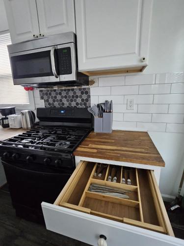 a kitchen with a black stove and a microwave at TKC Homes in Irvington