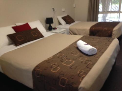 Giường trong phòng chung tại Kalua Motel