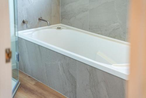 a white bath tub in a bathroom at Kinloch Getaway in Kinloch