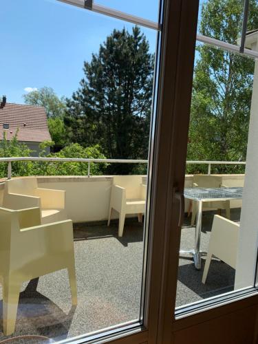 a view of a balcony with chairs and a table at La Chambre de Marie in Bouxwiller