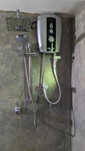 a hair dryer in the corner of a room at kingfish villa and restaurant in Ranna