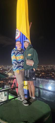 two people standing on top of a tower with a flag at Las Aguas Inner Experience in Bogotá