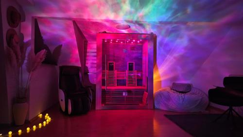 a room with a room with pink and purple lights at SAUNA - MASSAGE -Bodensee-Cinema Feeling- Home Sharing - Parking - Küche in Radolfzell am Bodensee