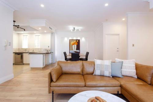 a living room with a couch and a table at Diamonds By The Dock Spacious,central Quality in Fremantle