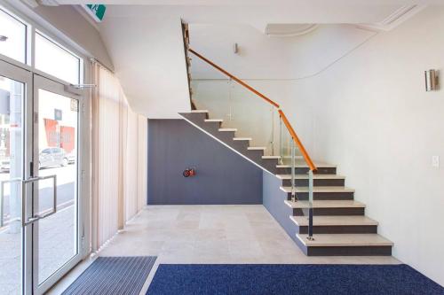 a staircase in a room with a large window at Diamonds By The Dock Spacious,central Quality in Fremantle
