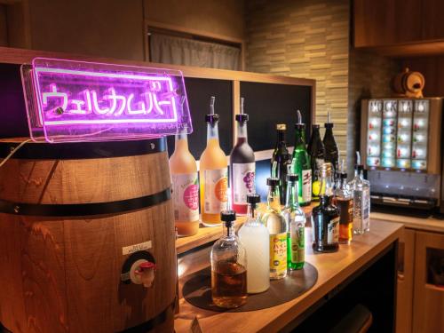 a bar with bottles of alcohol on a counter at Super Hotel Ueno-Okachimachi in Tokyo