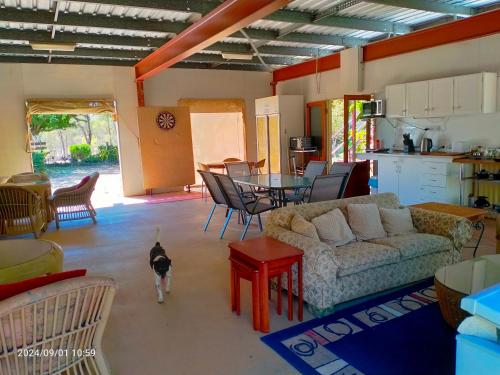 a living room with a couch and a table at Tamarind Gardens Camping, Caravans, Accommodation in Almaden