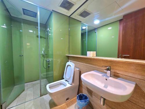 a bathroom with a sink and a toilet and a shower at Apartment Sky by MonoSuites KLCC in Kuala Lumpur