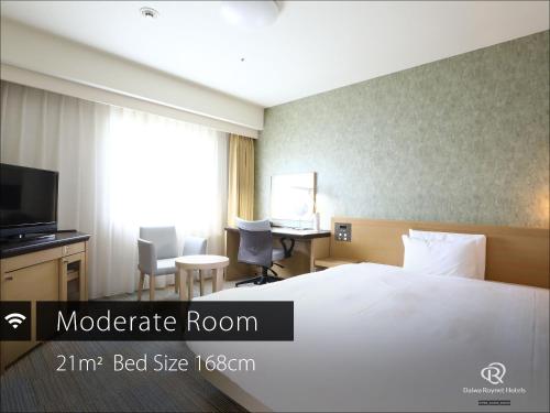 a hotel room with a bed and a desk at Daiwa Roynet Hotel Takamatsu in Takamatsu