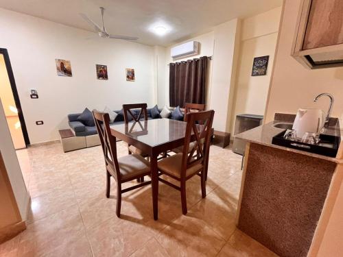 a kitchen and dining room with a table and chairs at Reef House in Marsa Alam City