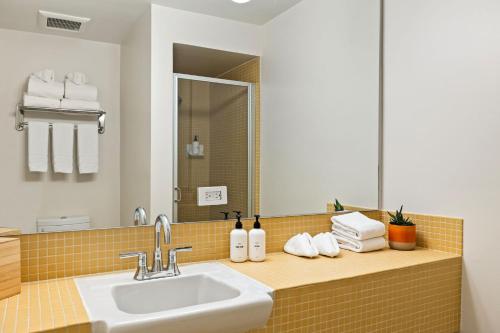 a bathroom with a sink and a mirror at Mojave Resort - Adults Only in Palm Desert
