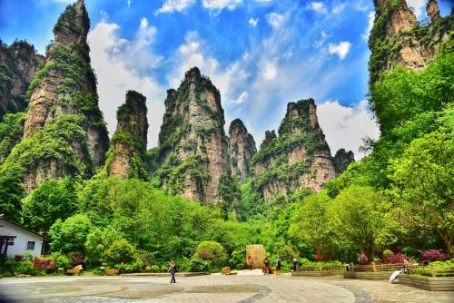 a view of a mountain range with trees and people at Zhangjiajie DreamWay Hotel - Free pick up service in Zhangjiajie