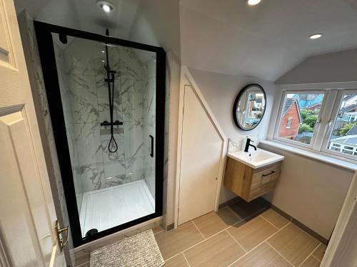 a bathroom with a shower and a sink at 12 Clos Yr Wylan in Barry