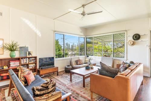 a living room with a couch and a table at Sharon - Pet Friendly Beach Cottage in Town - Holiday Yamba in Yamba