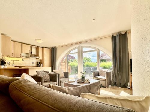 a living room with a couch and a table at Haus Emmi - Hooksiel in Wangerland