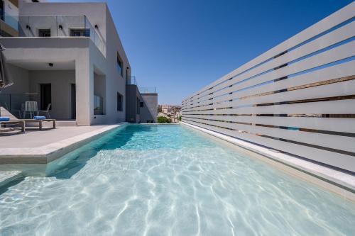 a swimming pool in front of a house at ArtCotel Luxury Villa in Rethymno Town