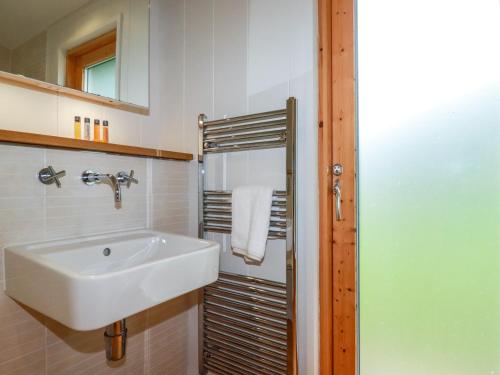 a bathroom with a sink and a mirror at 1 Hedgerows in Looe