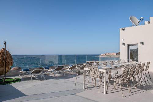 a table and chairs on the roof of a building at ArtCotel Luxury Villa in Rethymno Town