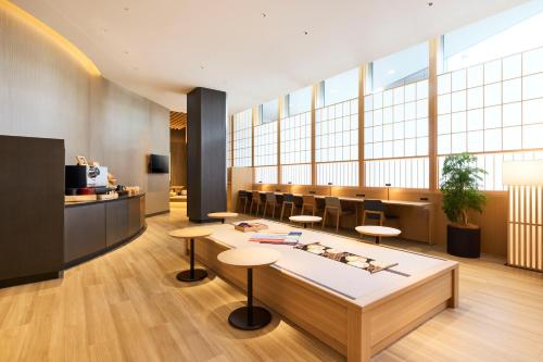 an office lobby with a table and stools at Cerulean Tower Tokyu Hotel, A Pan Pacific Partner Hotel in Tokyo